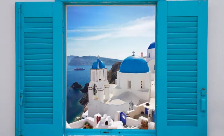 Light blue windowsill, overlooking blue and white Mediterranean domed houses.