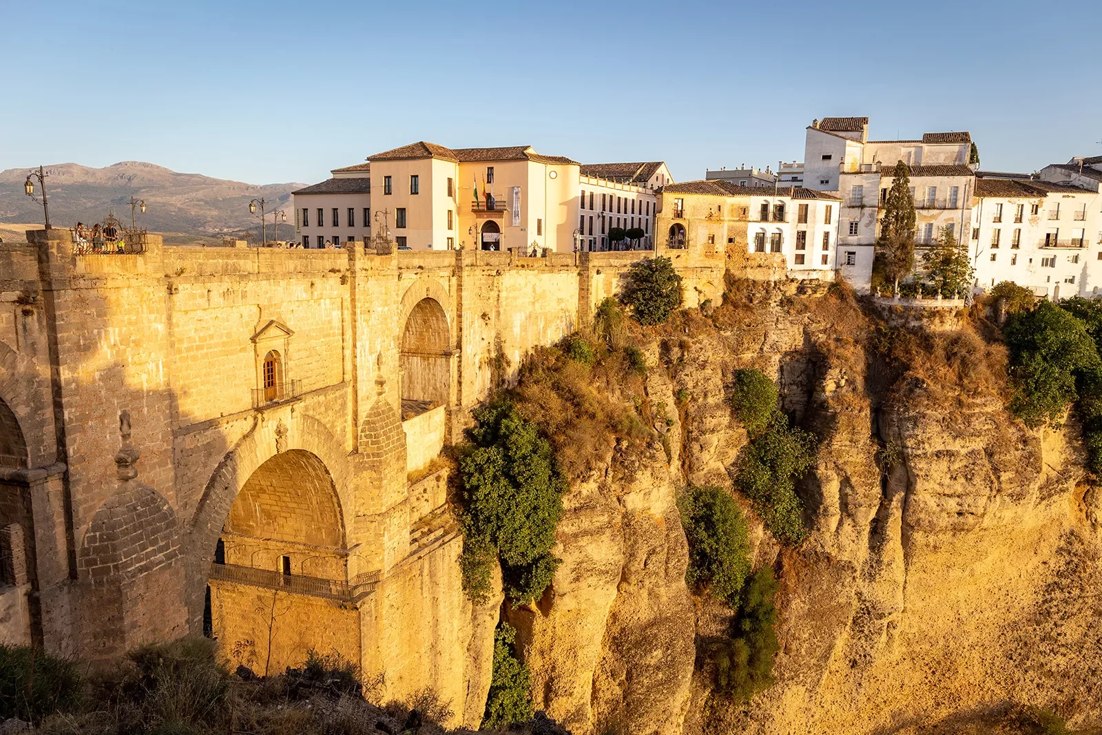 Spanish buildings on top of a cliff with dramatic drop.