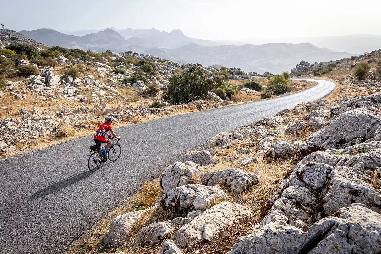 Biker riding on a road in Spain.