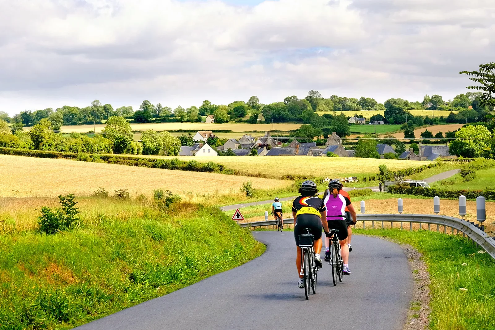 Cyclists riding through countryside
