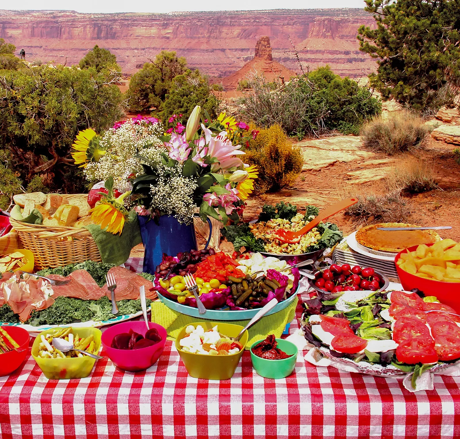 Picnic table spread with mountains in background