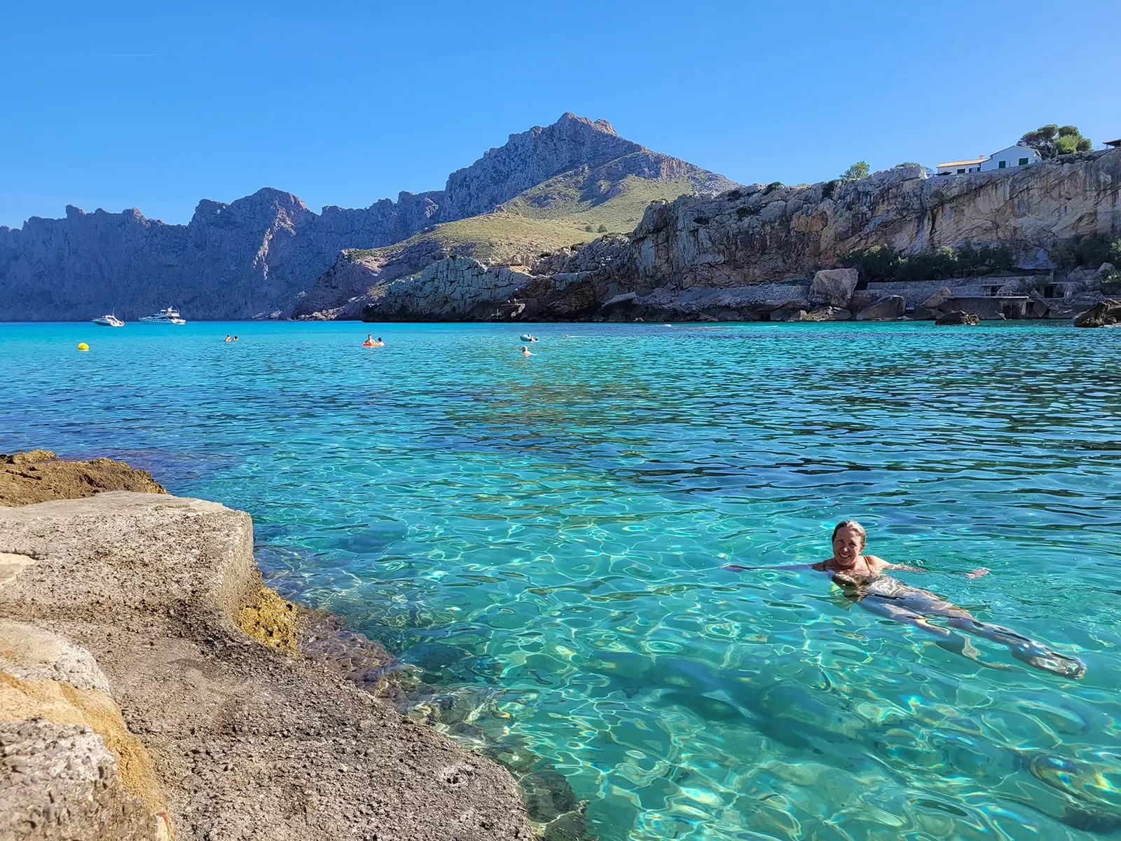 Person swimming in clear blue water in Mallorca.
