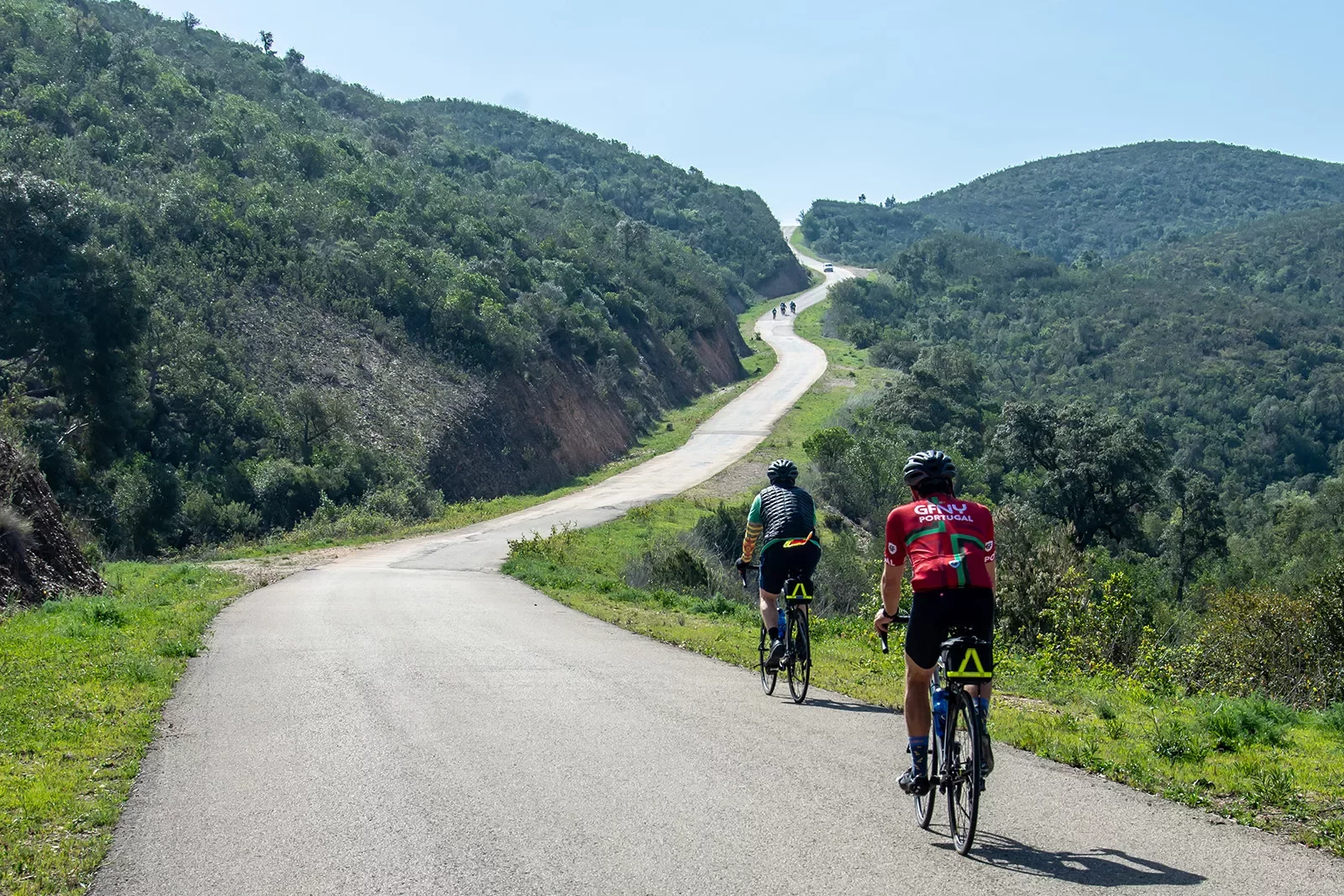Backgrounds guests biking up hill in Portugal.