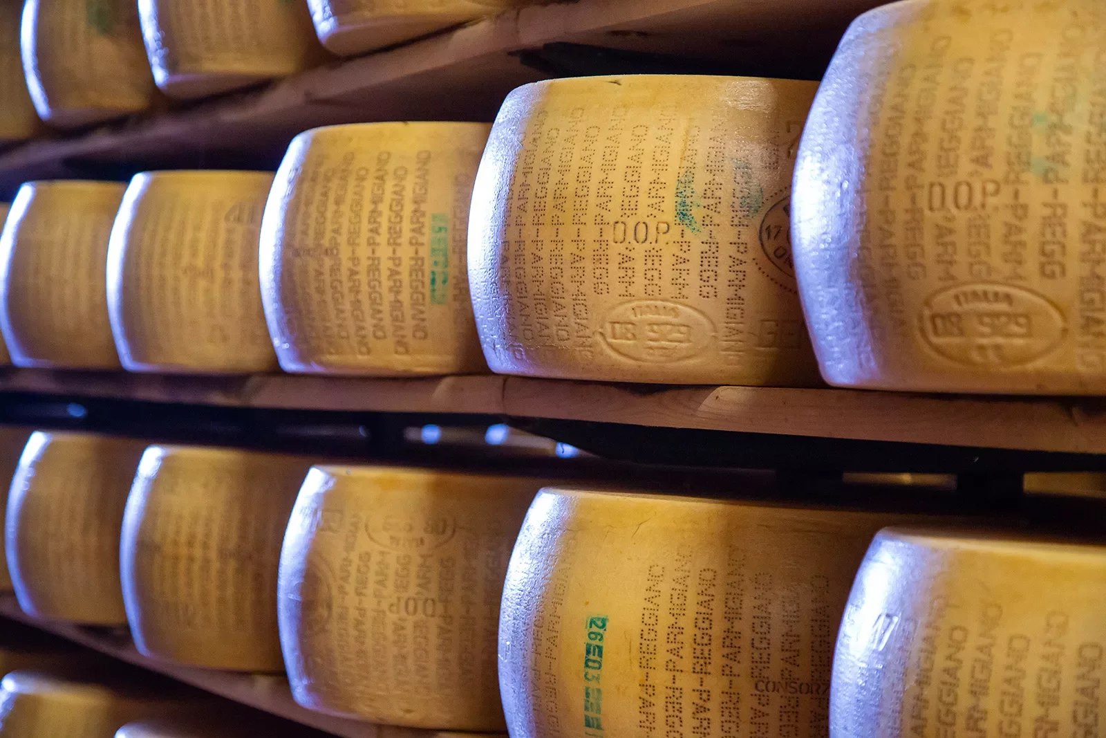 Shelves filled with wheels of Parmigiano Regiano