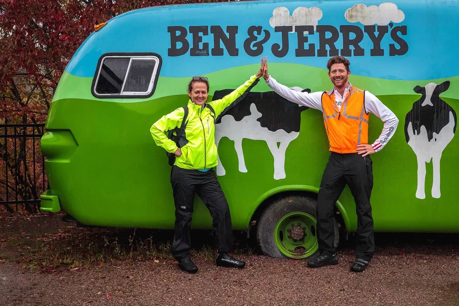 Two guests high-fiving in front of Ben &amp; Jerry's car.