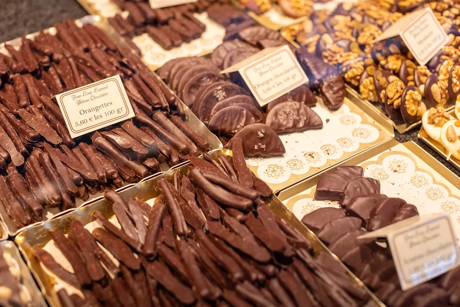 Close-up of confectionary shop. Chocolate orange peels, slices seen.