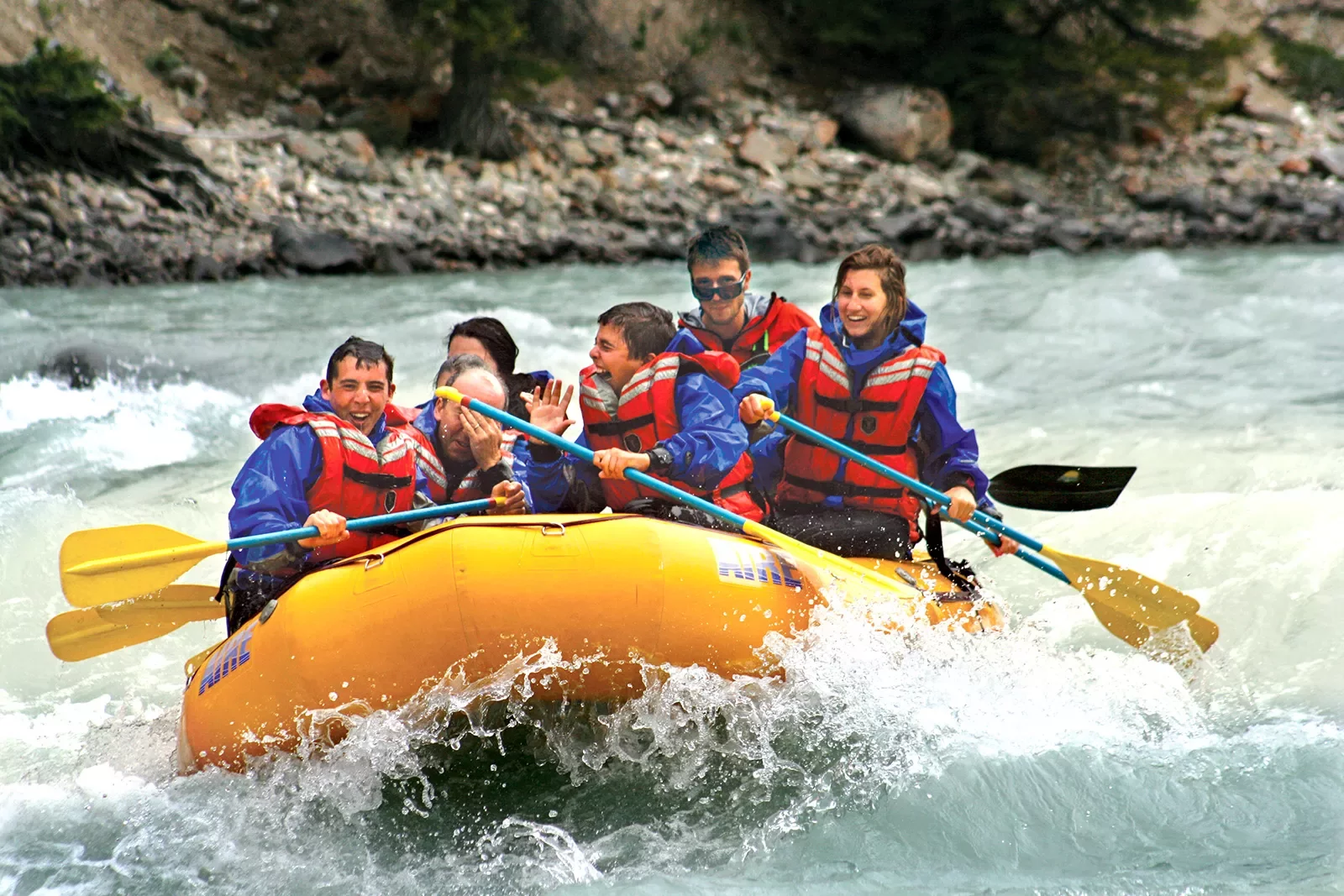 Family rafting down a river in Canada