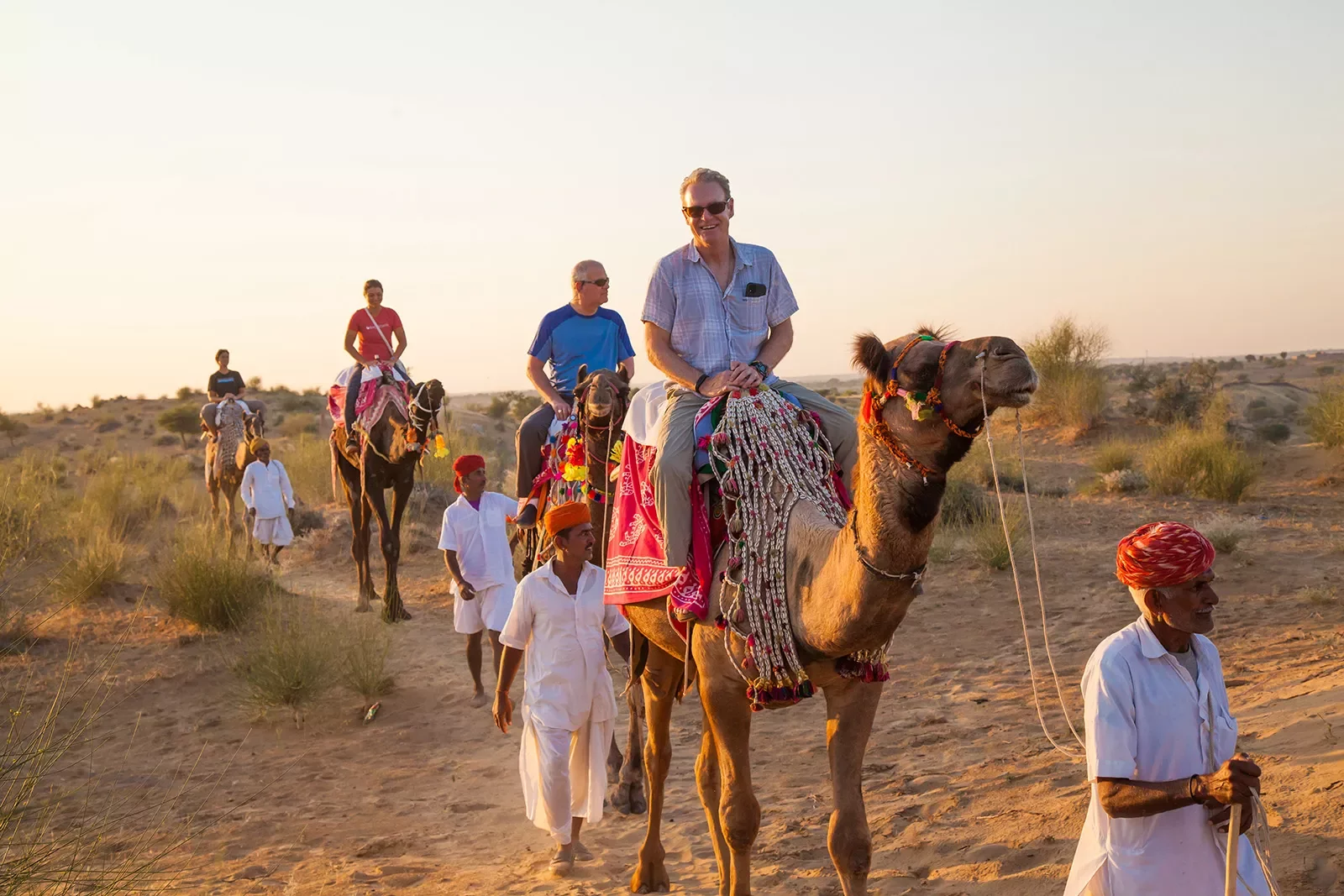 backroads guests riding camels in the desert in India