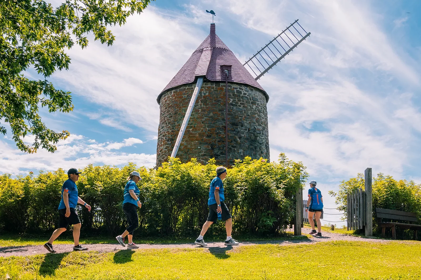 Four guests walking up towards windmill.