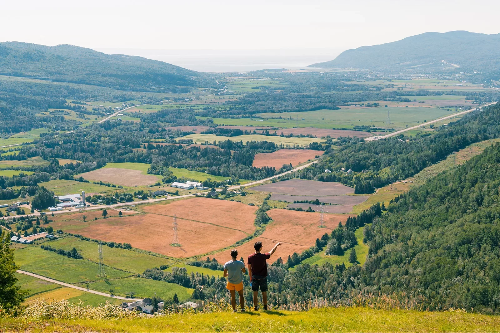 Two hikers overlooking a valley in Quebec, Canada
