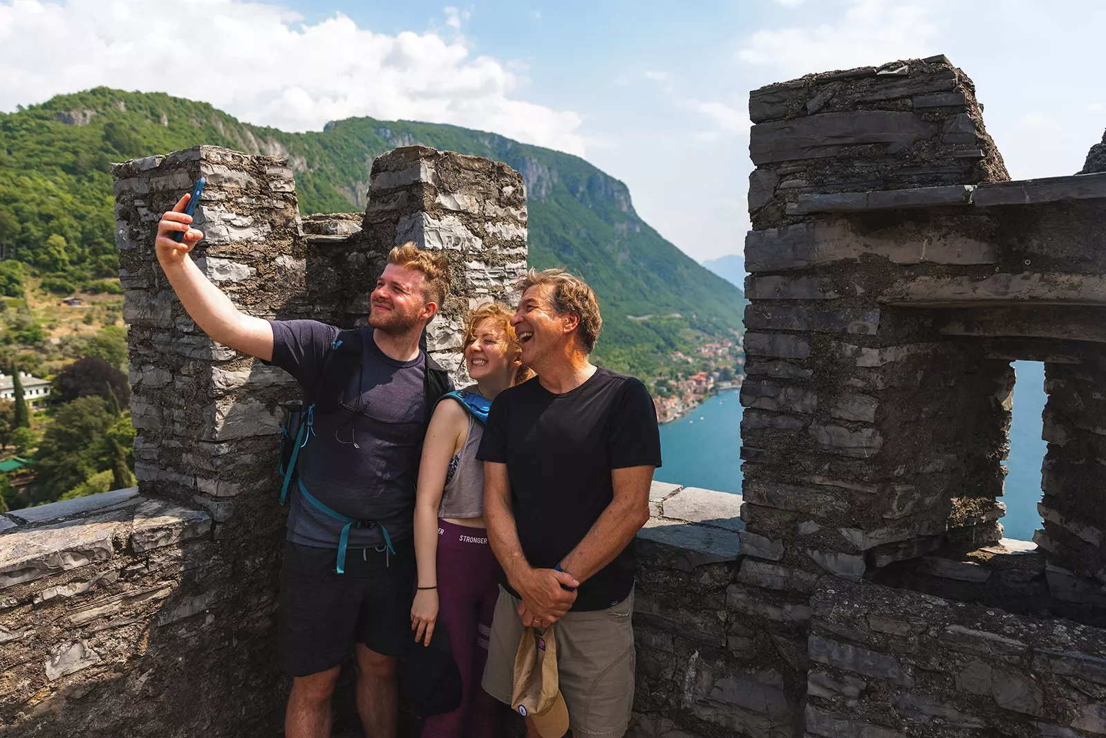 Three guests taking selfie on castle roof.