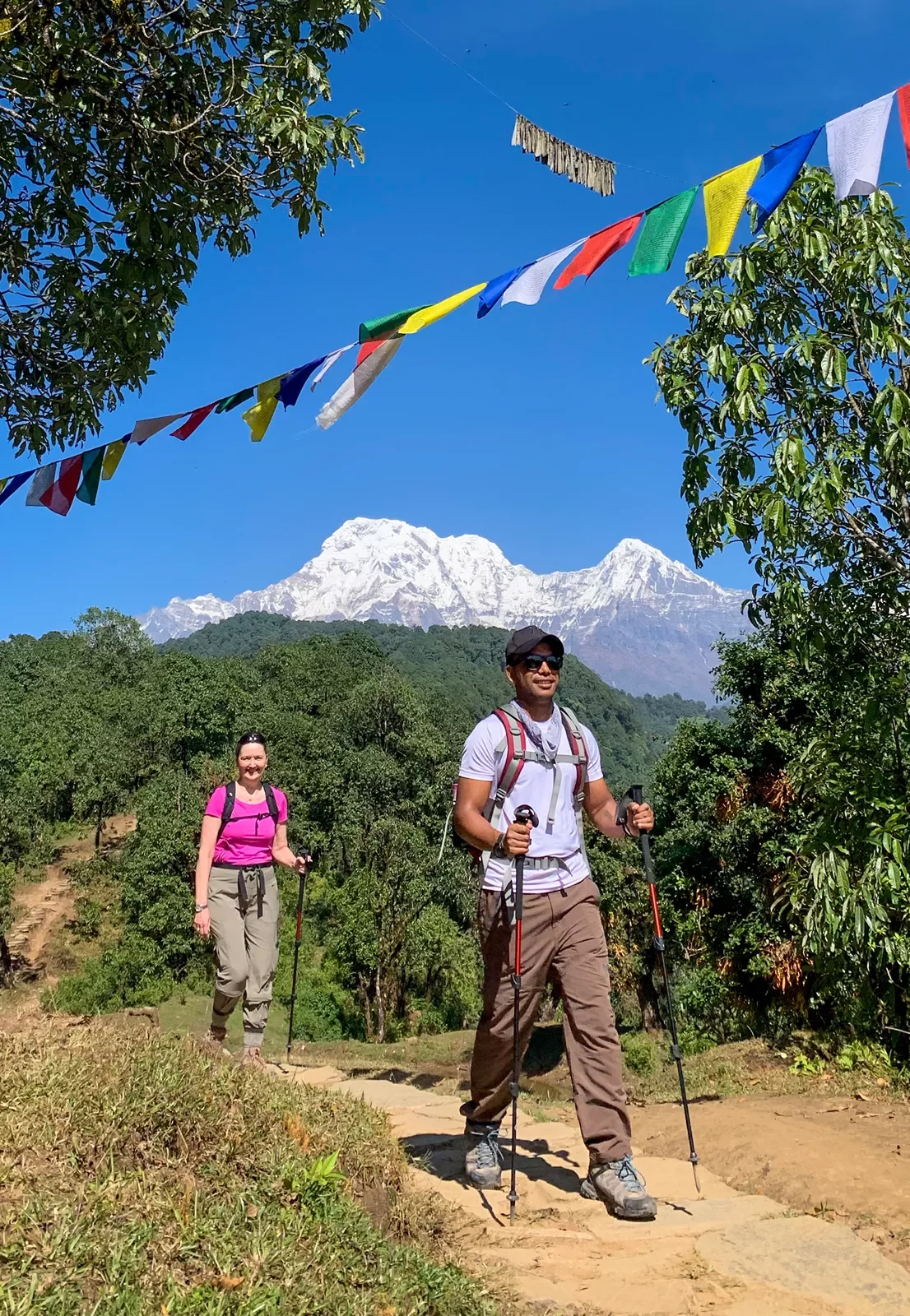 Hiking along a dirt path with mountains in the background in Nepal