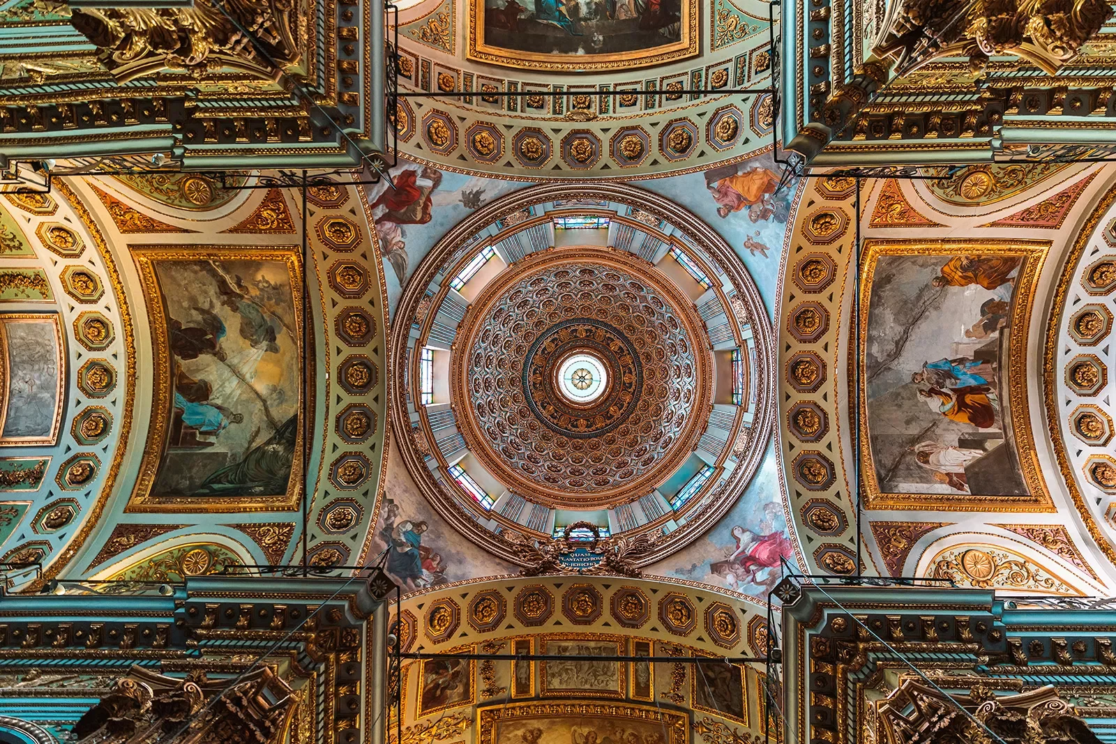 Shot of ceiling in domed church, mosaics and art on ceiling.