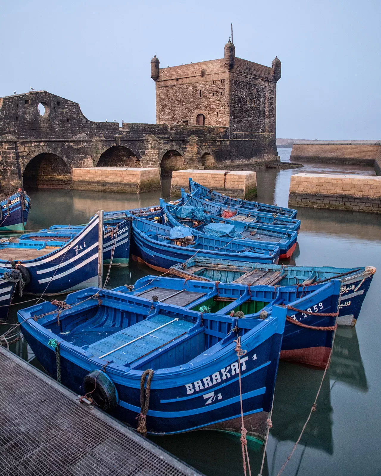 Port of Essaouira, blue scows docked in foreground