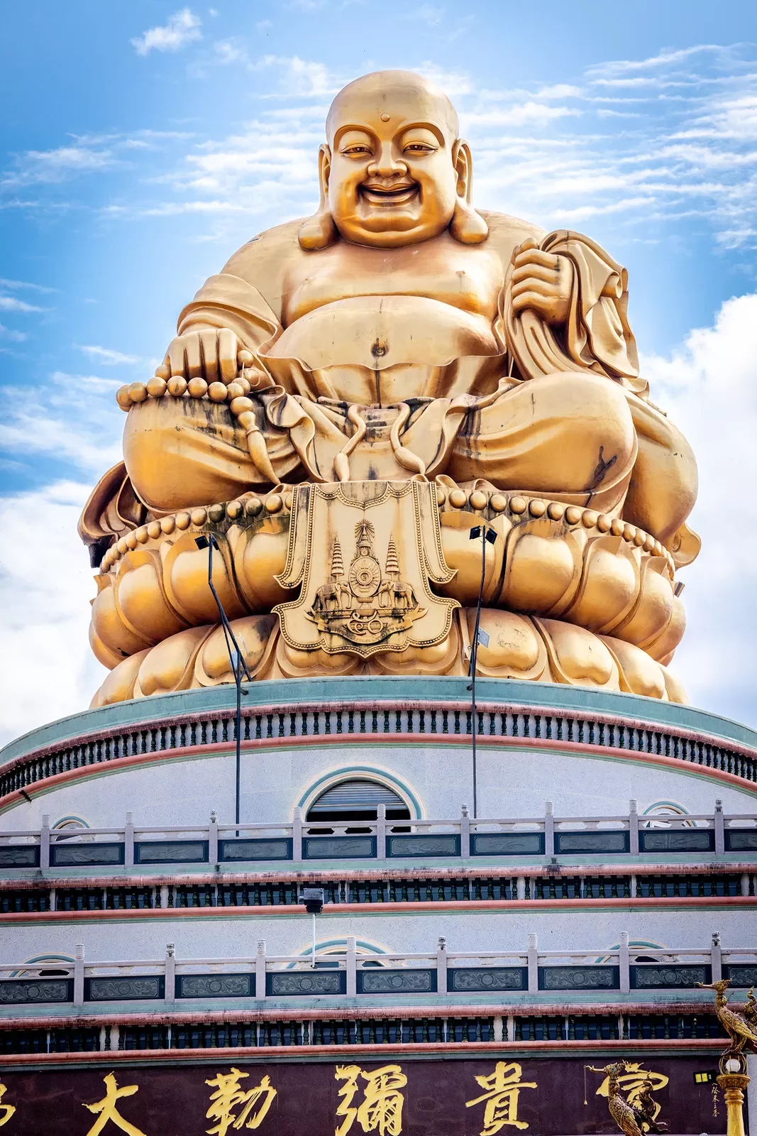 Large gold Buddha statue on top of building
