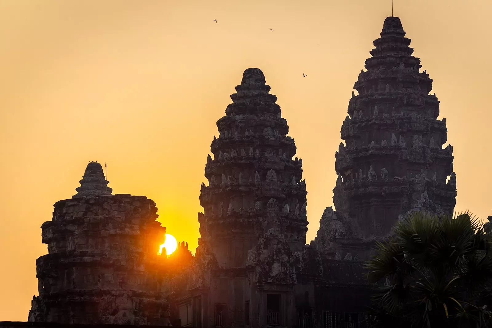 Sun setting behind stone temples