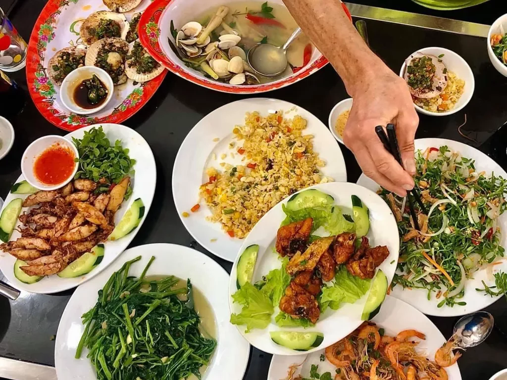 Spread of Vietnamese food, fried rice, meat, seafood, veggies, etc.