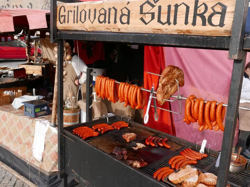 Traditional meats and sausages being sold by a street food vendor