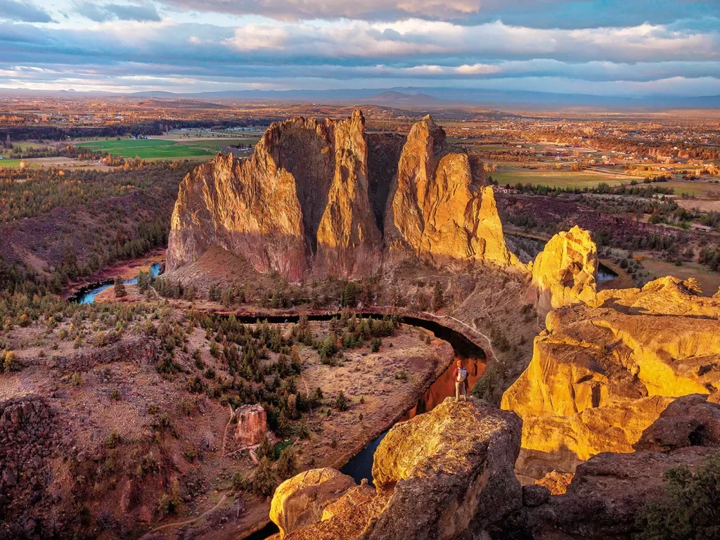 Wide shot of Smith Rock State Park, guest visible in foreground.