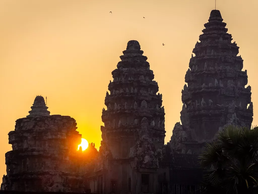 Sun setting behind stone temples