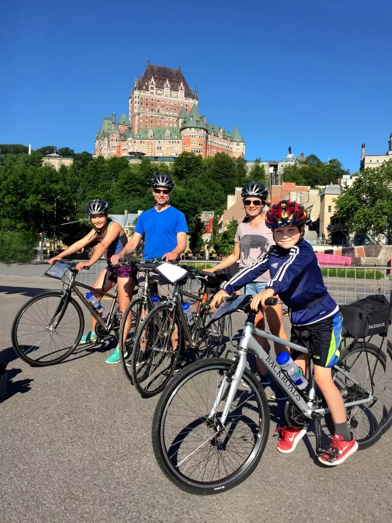 Guest family on their bikes, Fairmont Le Château Frontenac in background.