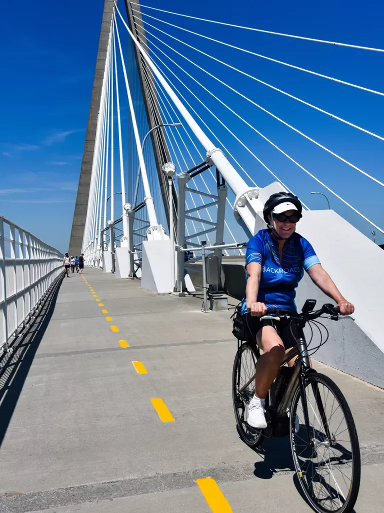Guest cycling on large bridge.