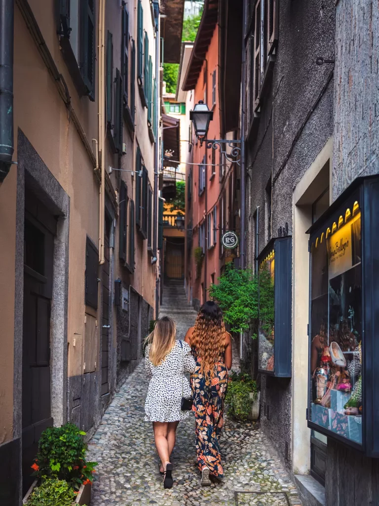 Two guests walking down narrow alleyway.