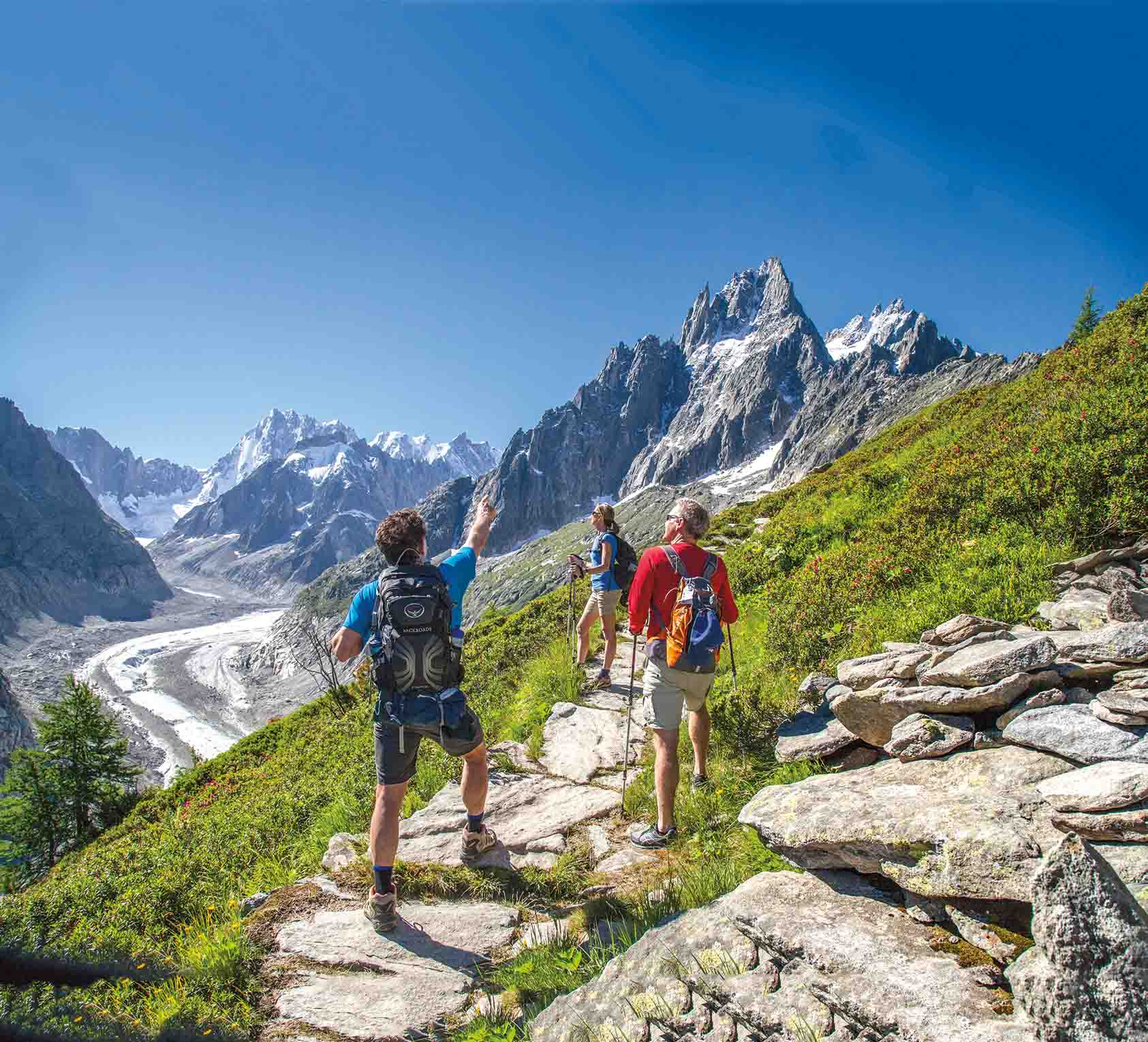 Two hikers high up on a mountain trail