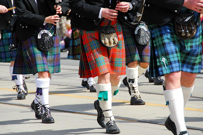 Troupe of bagpipers playing while marching