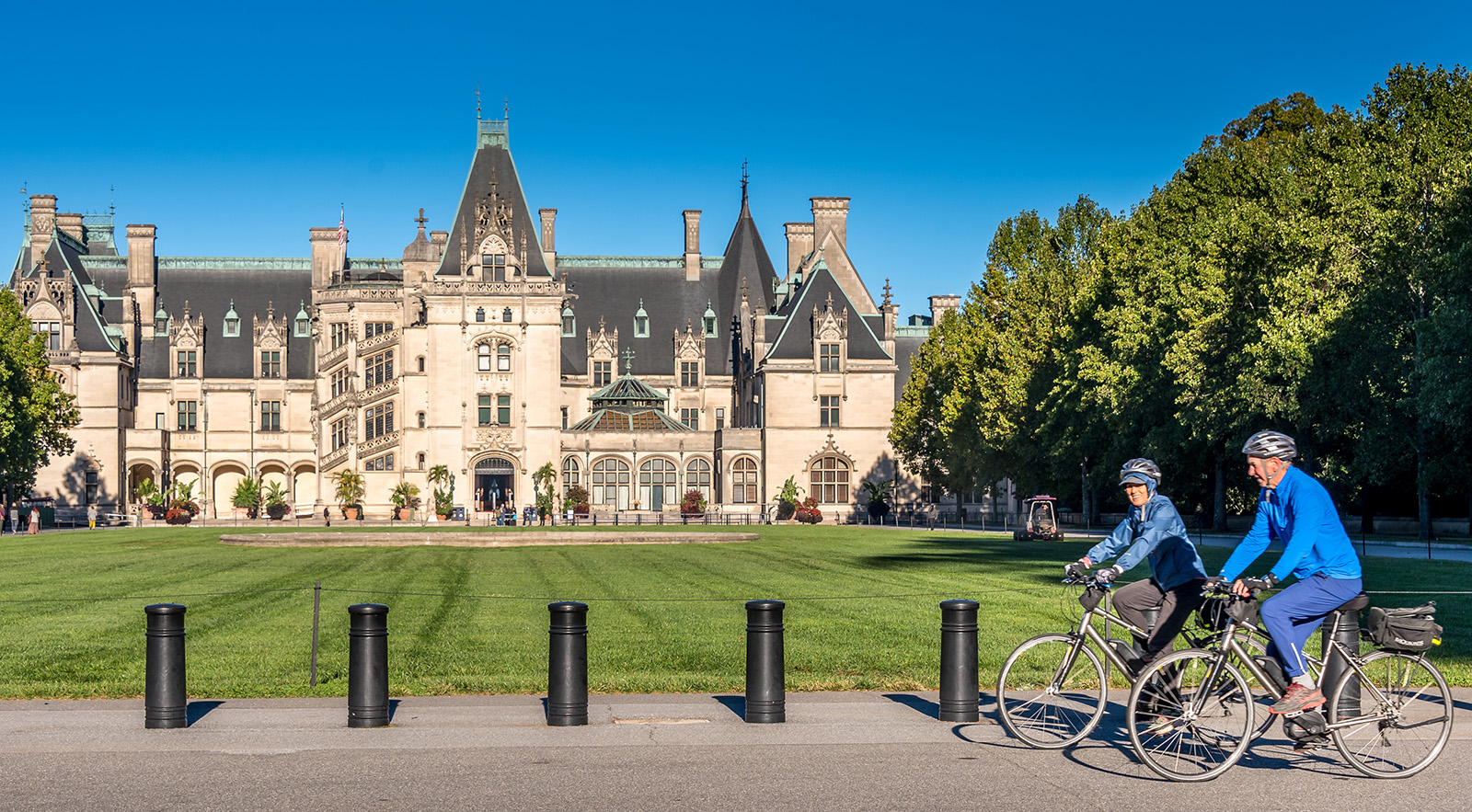 Guests biking in front of the Biltmore Estate.