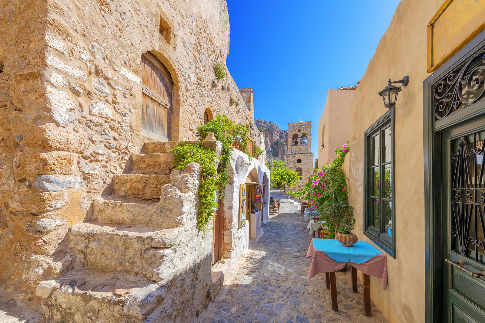 POV shot of someone walking down beachy stone alleyway.