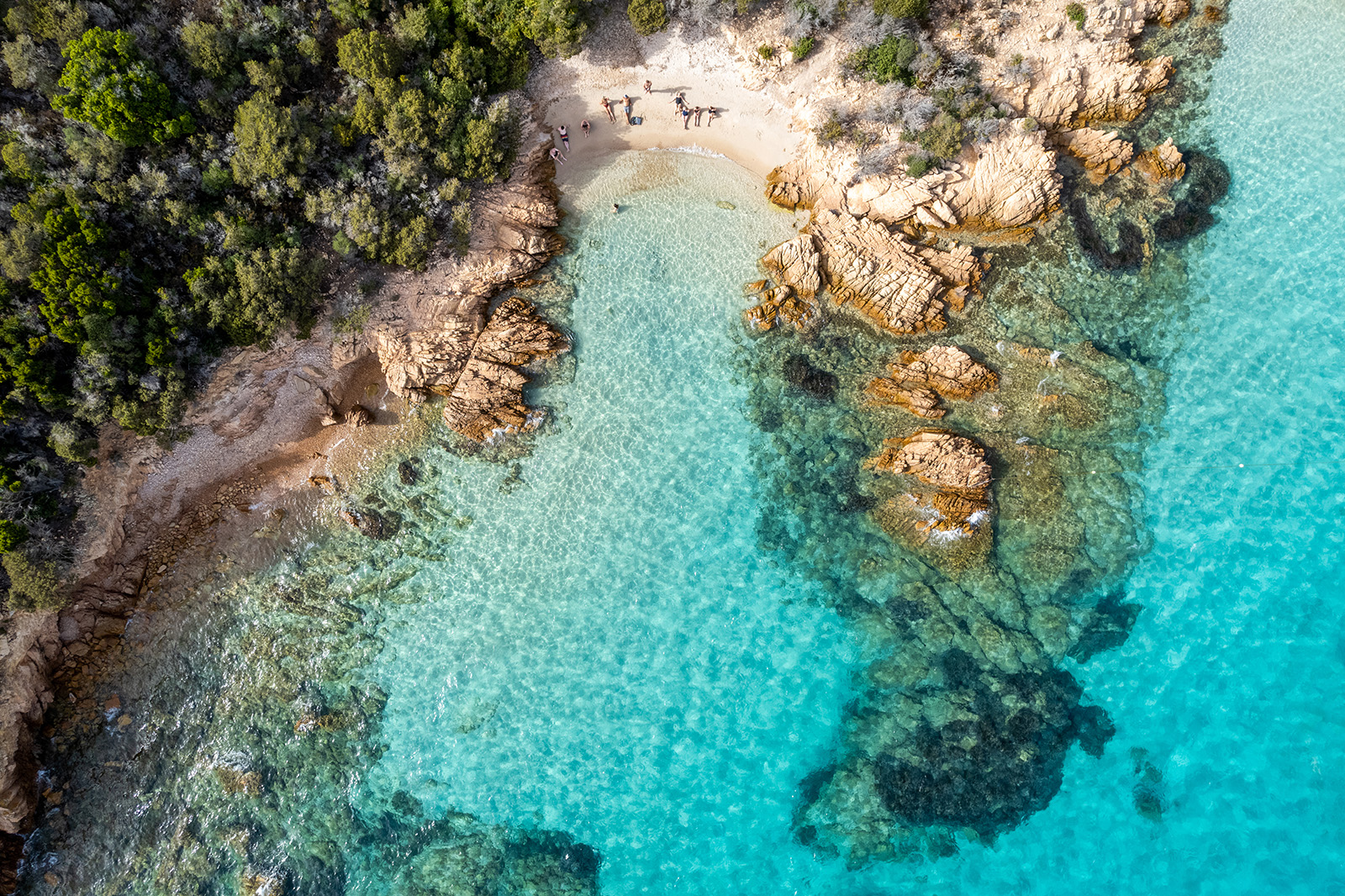Bird's eye shot of blue-water coastline.