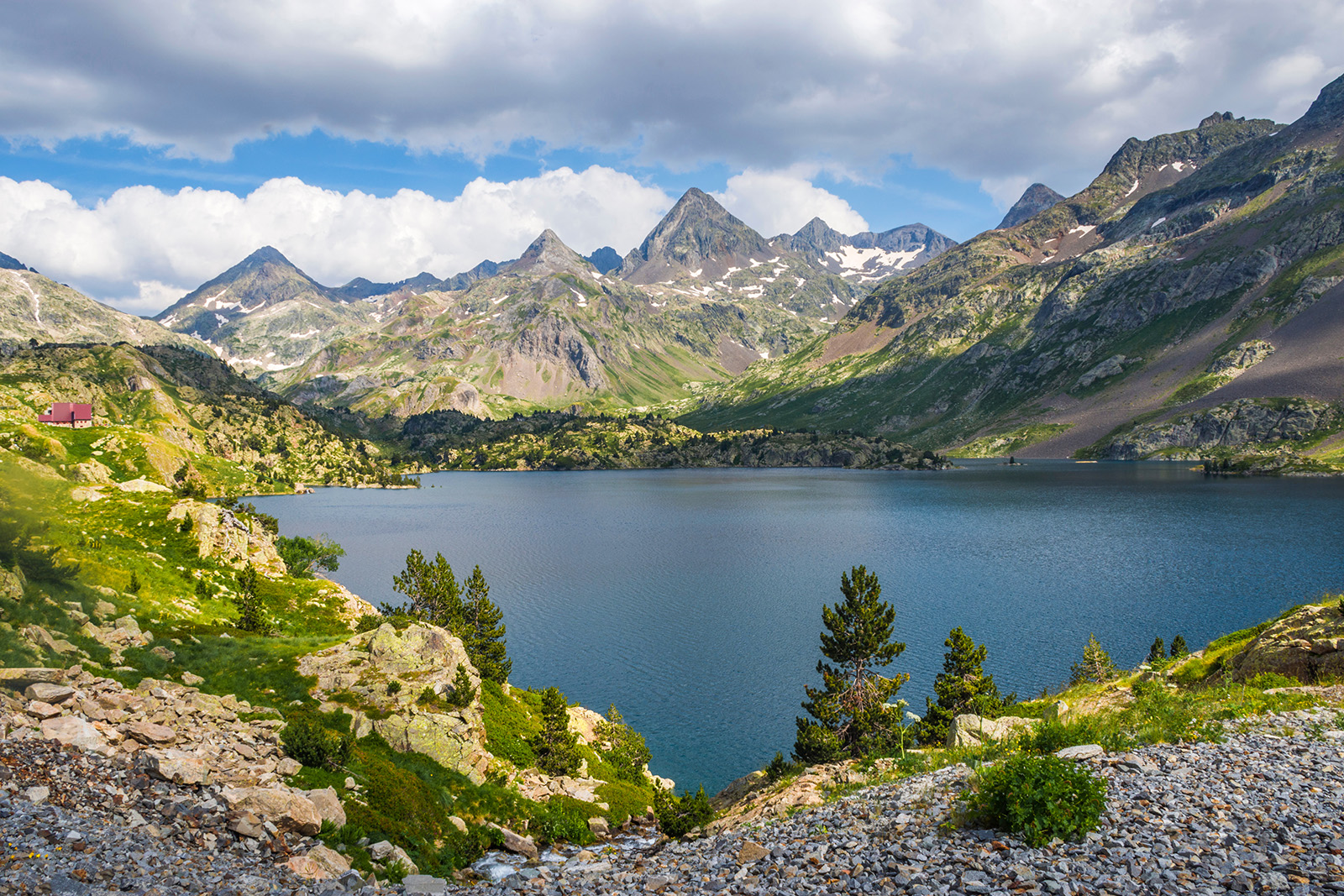Wide shot of Respomuso Reservoir, mountains all around.