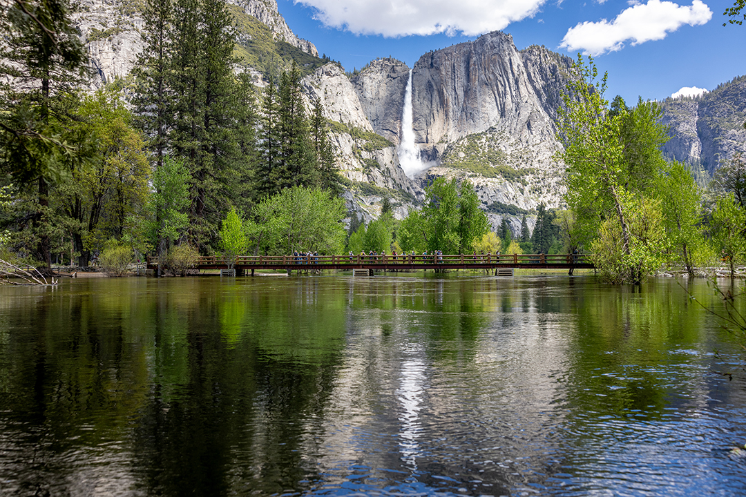 Large open lake with a reflection of a tall mountain from the background