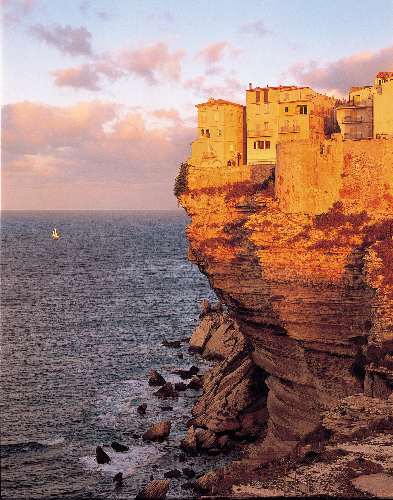 Sunset on cliffside next to the ocean