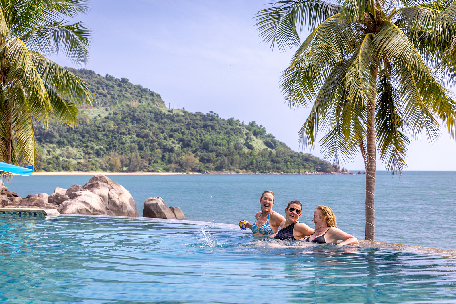 people lounge in a beach front pool