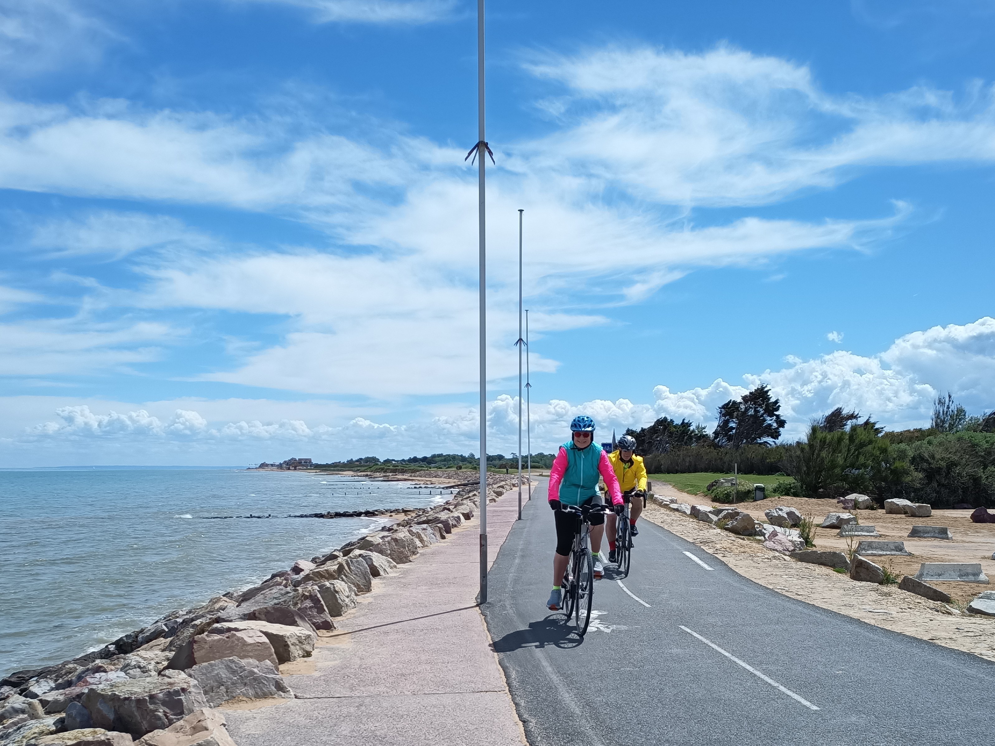 Two bikers on a coastline road