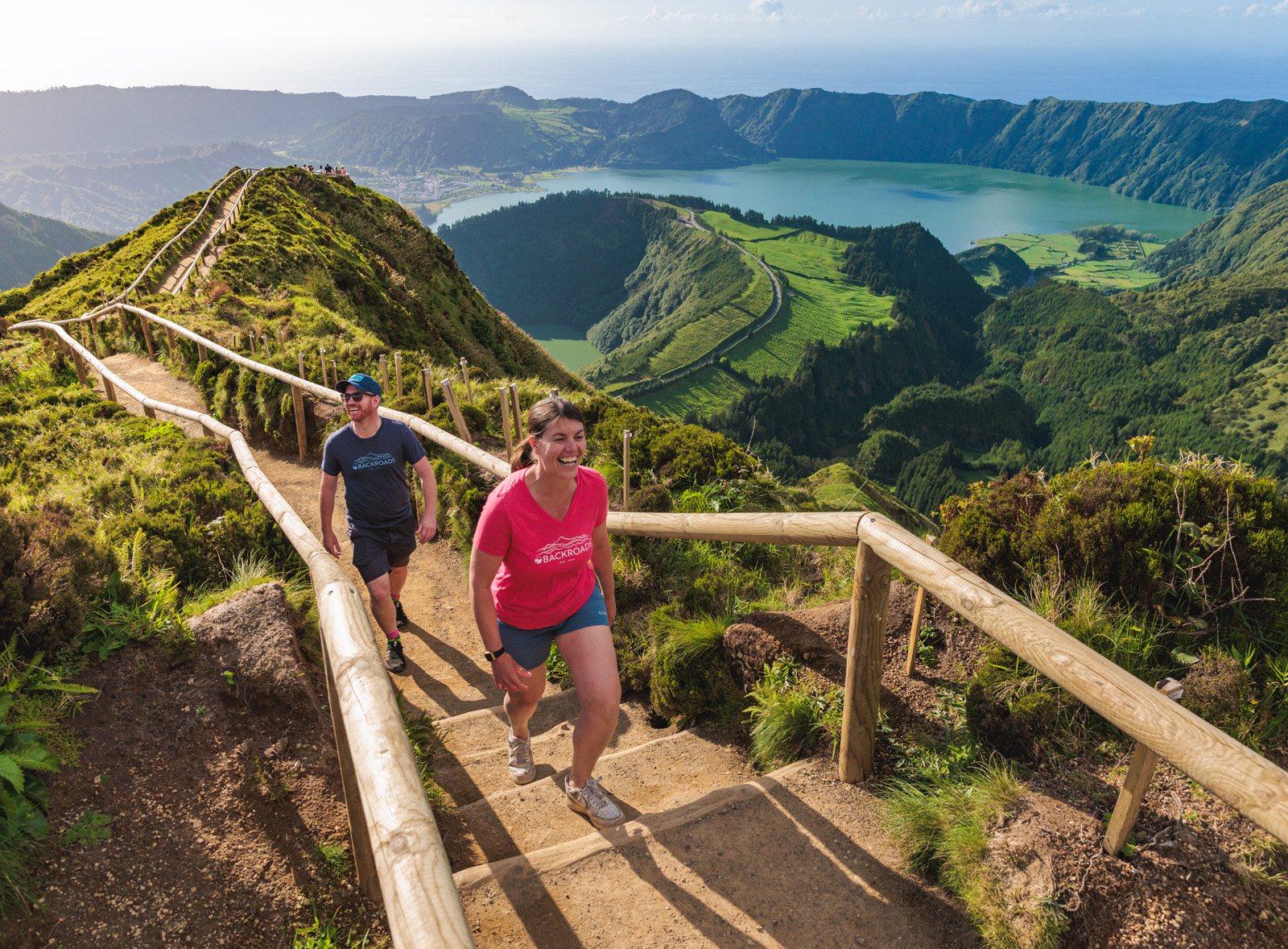 Man and woman walking up stairs on a path on a hill