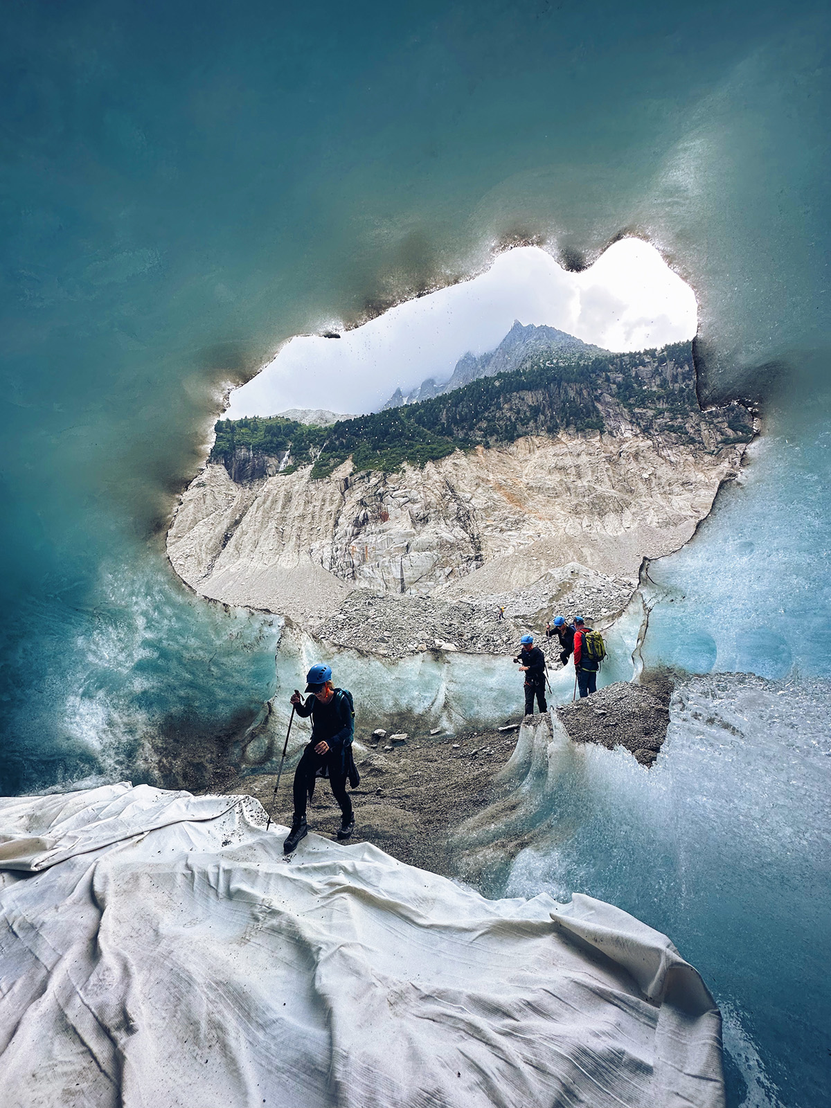 Hikers walking through icy alps path