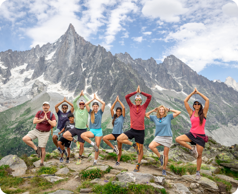 Group of Backroads hikers doing a yoga pose in the Alps