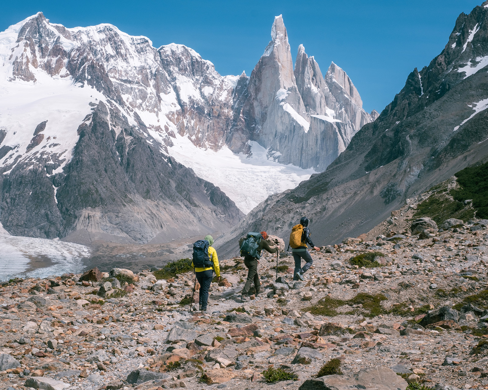 hikers walking against snowey mountains