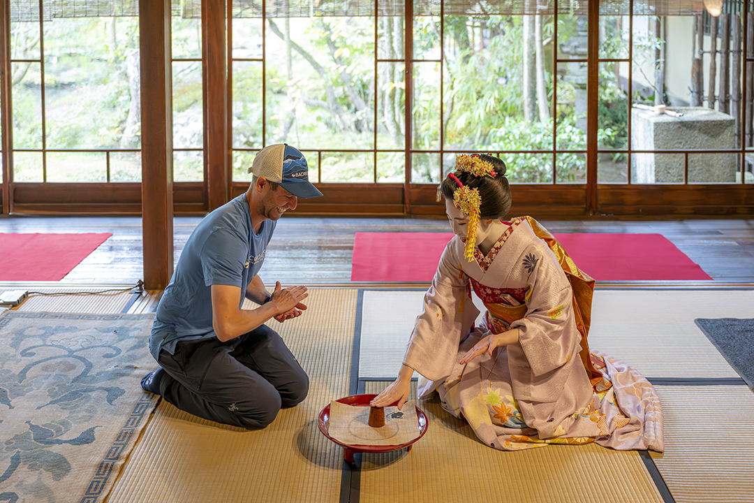 Man and geisha in a traditional Japanese building