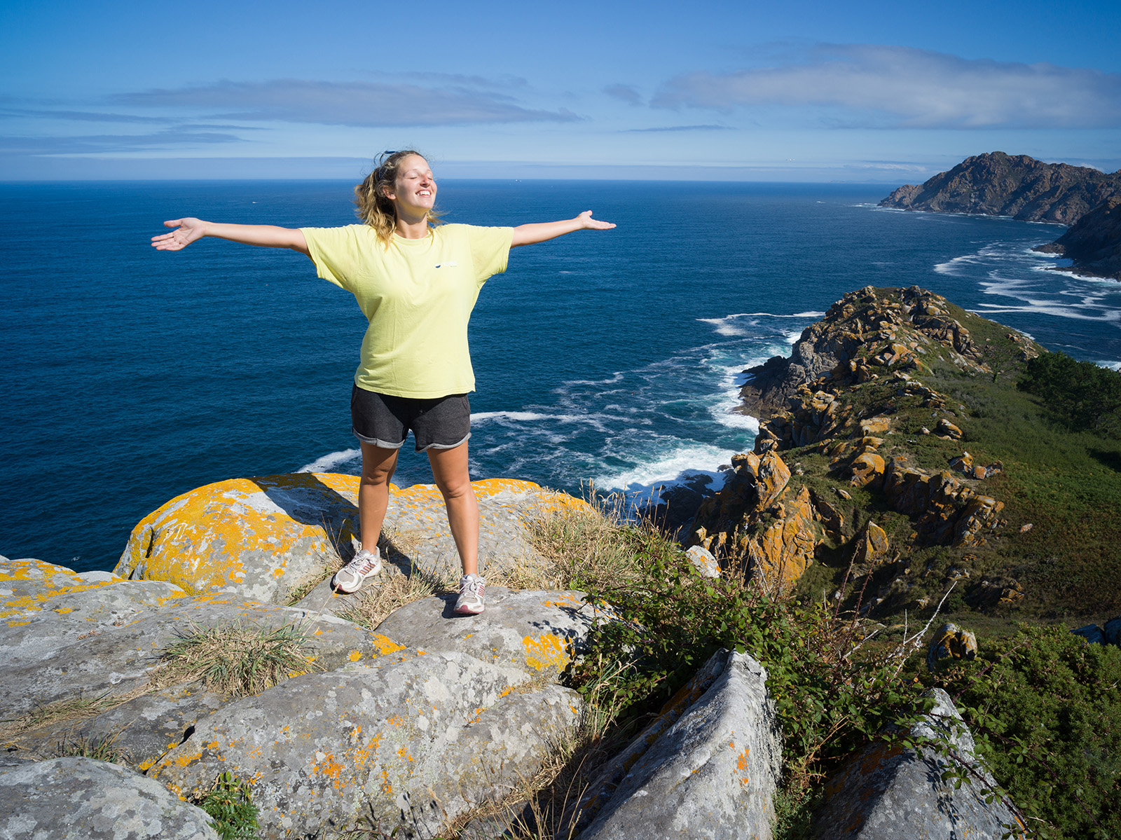 A person standing on top of a rock