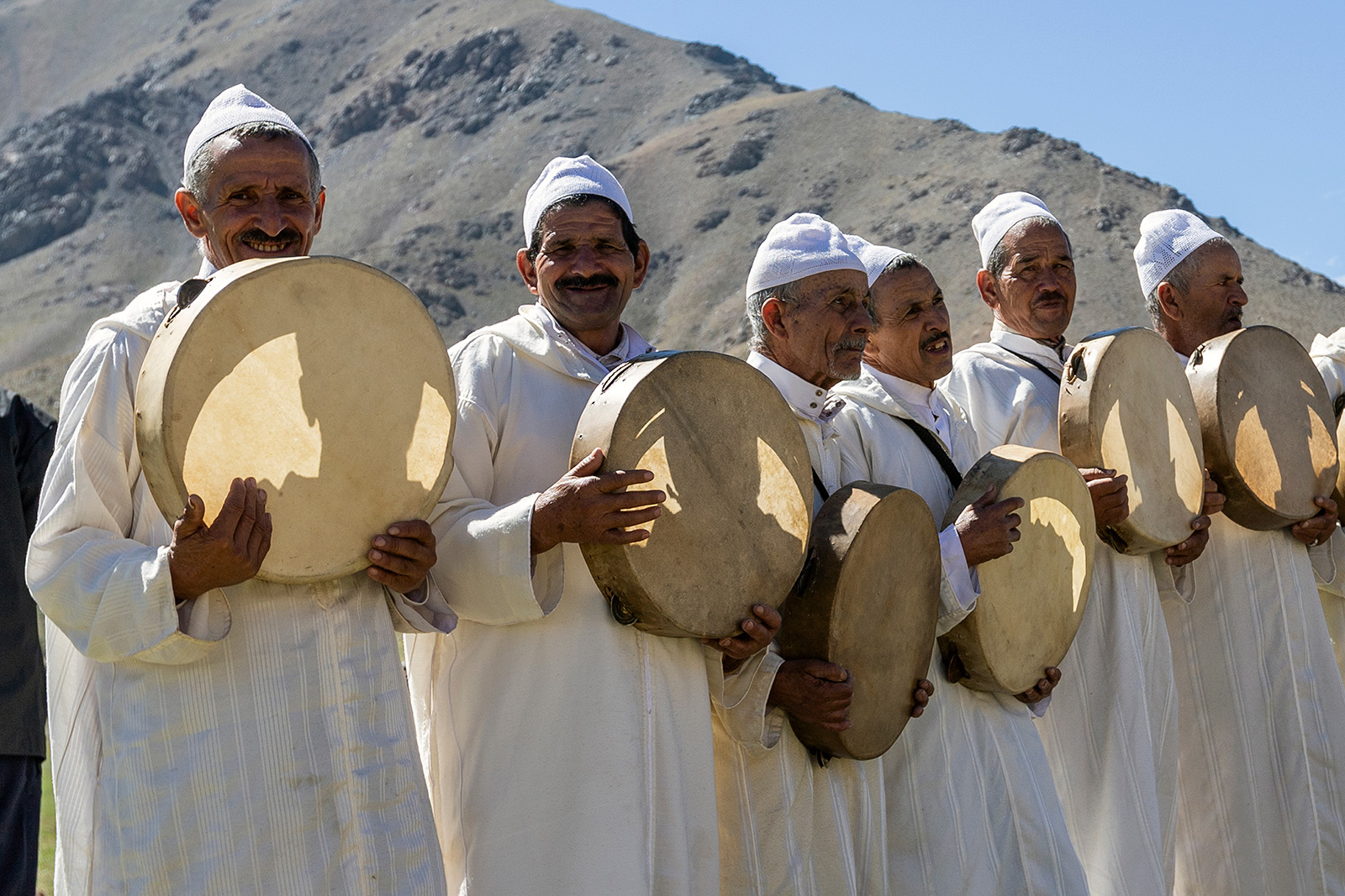 Group of men holding cloths, circular instruments