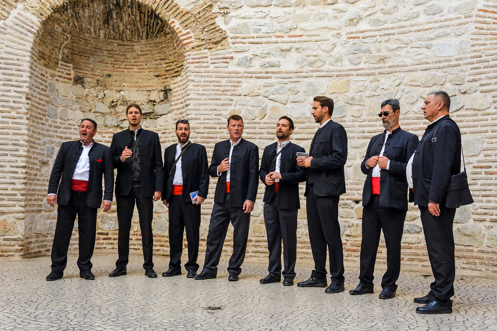 Group of men in suits singing