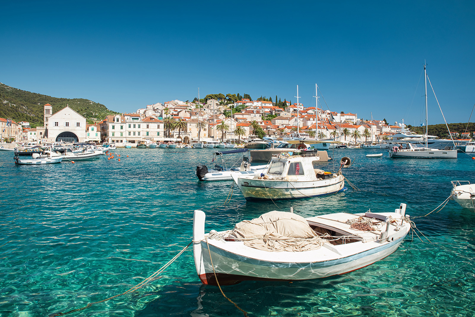 Boats floating on the water by a coastal town