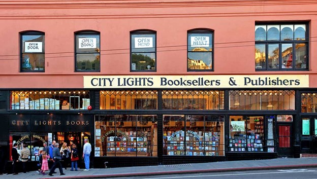 Exterior view of red bookstore with a crowd of people in front