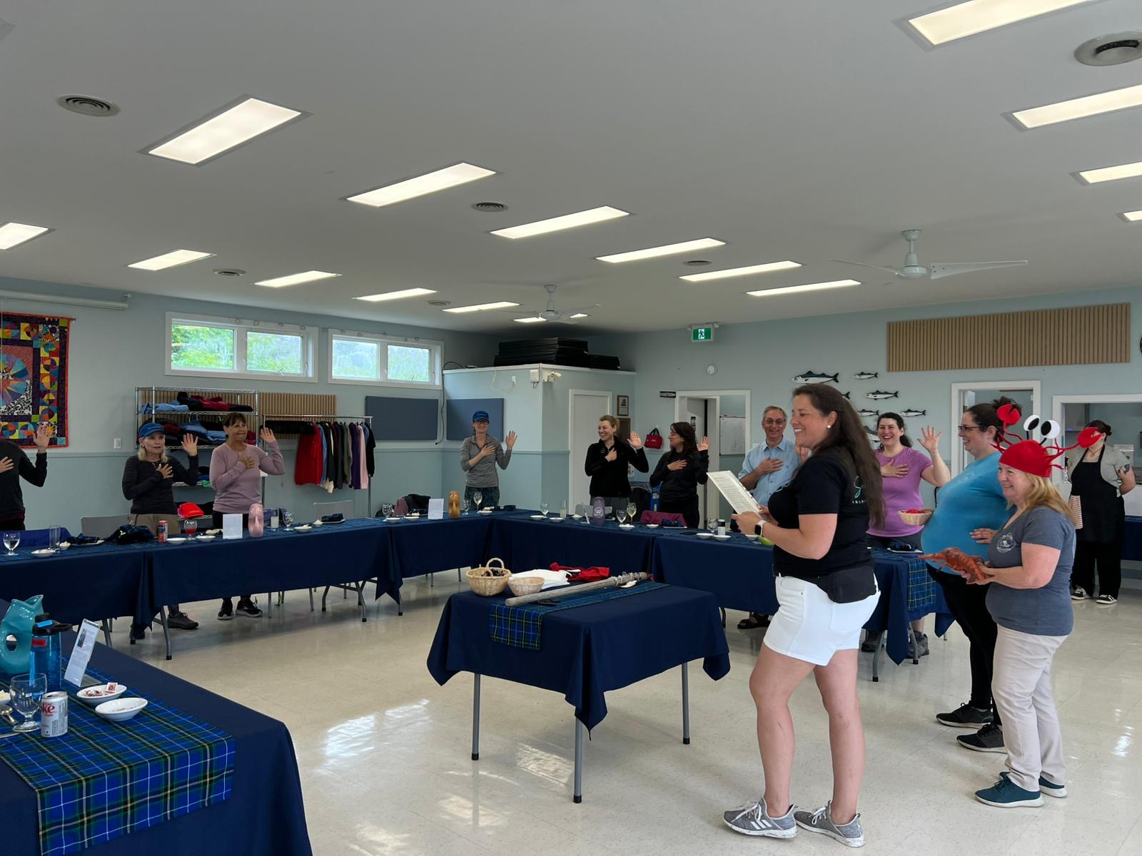 Group of people standing in a circle with their hands over their hearts