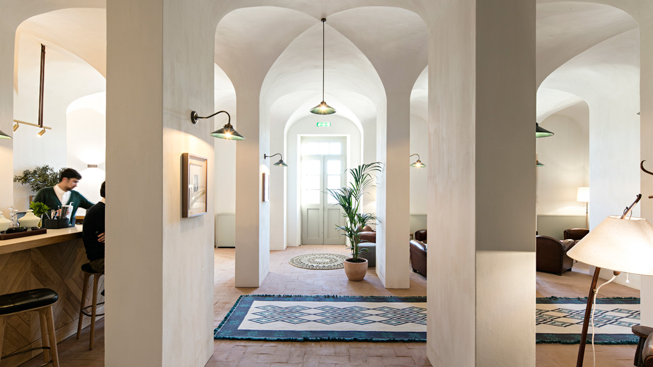 Hotel lobby with large, beige pillars with a counter to the left