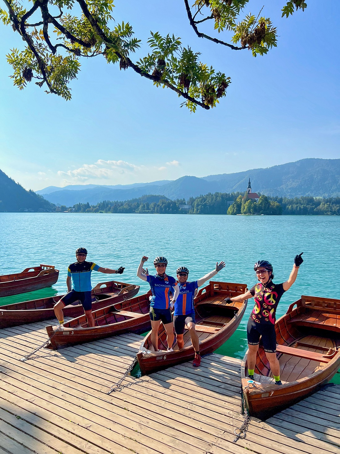Group of people standing on wooden boats by a large lake